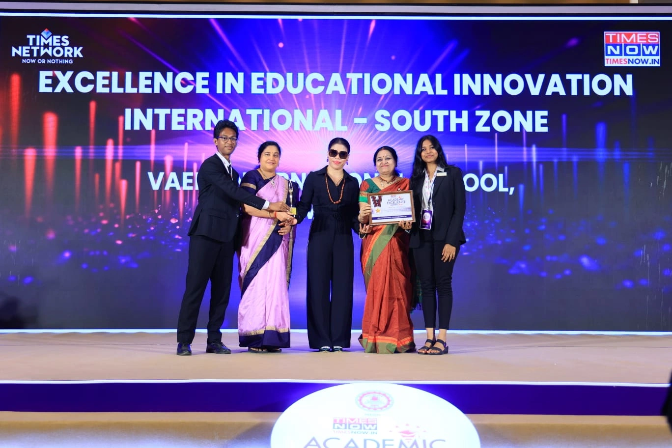 Vaels International School representatives receiving a national award on stage