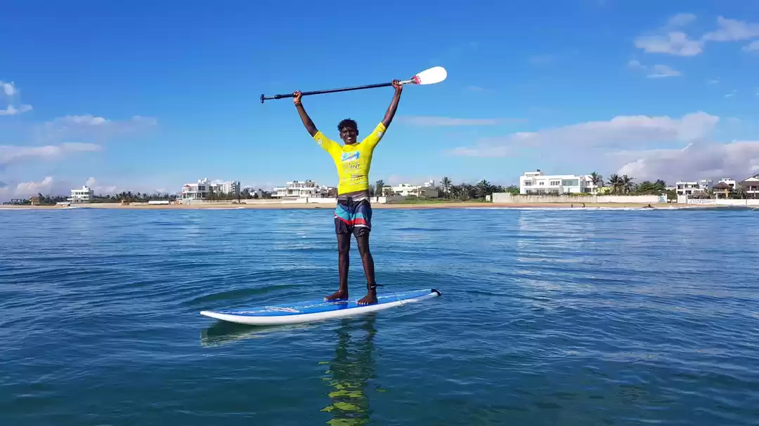 Stand-up paddleboarding on calm morning water