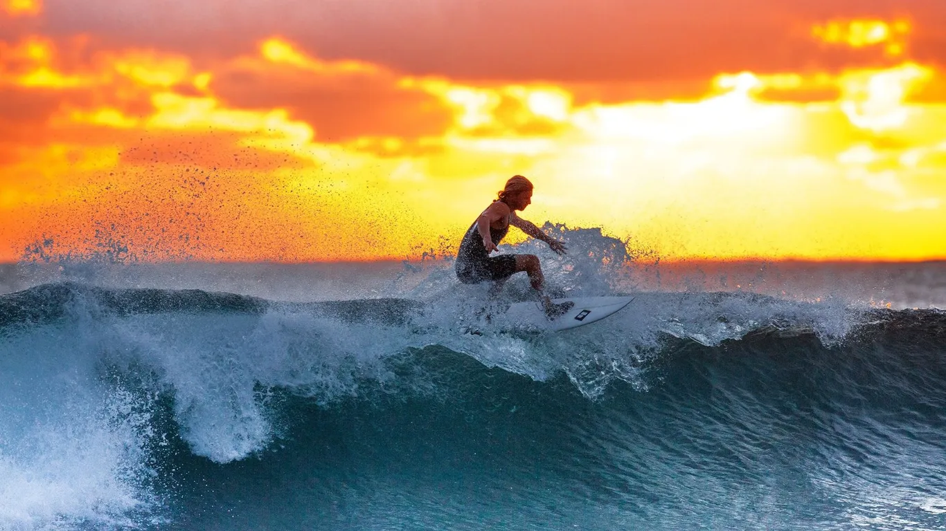Surfing the evening swell at golden hour