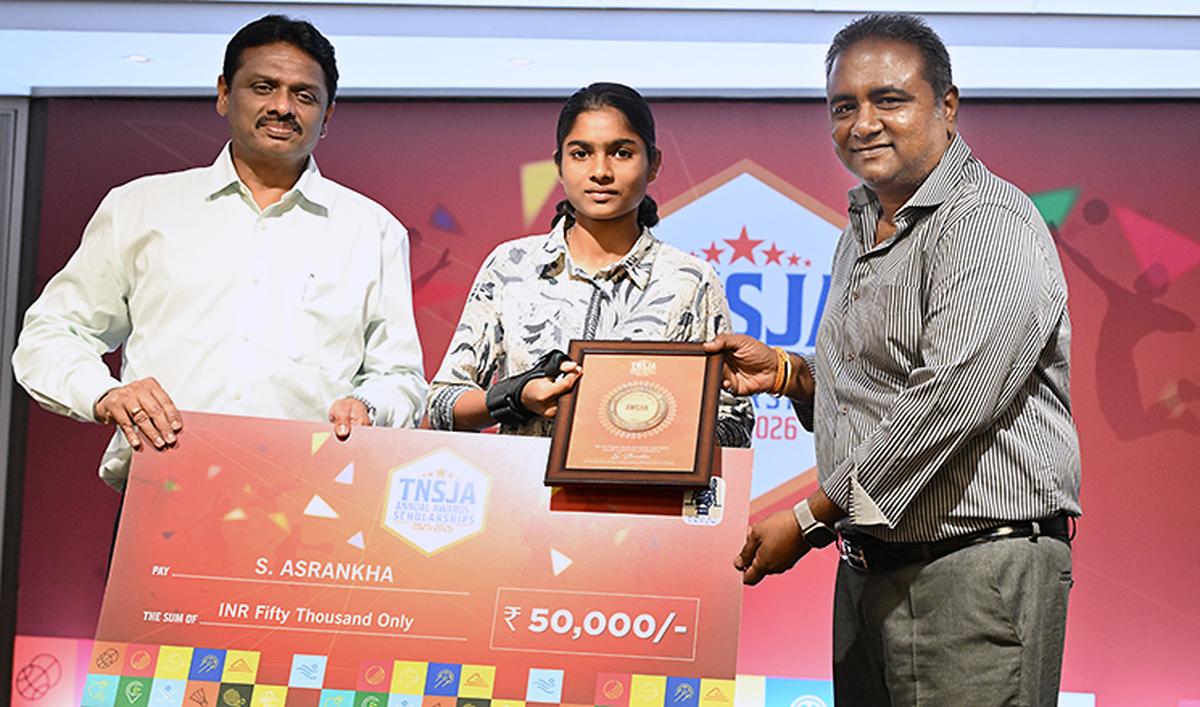 A scholarship awardee receives her grant and citation