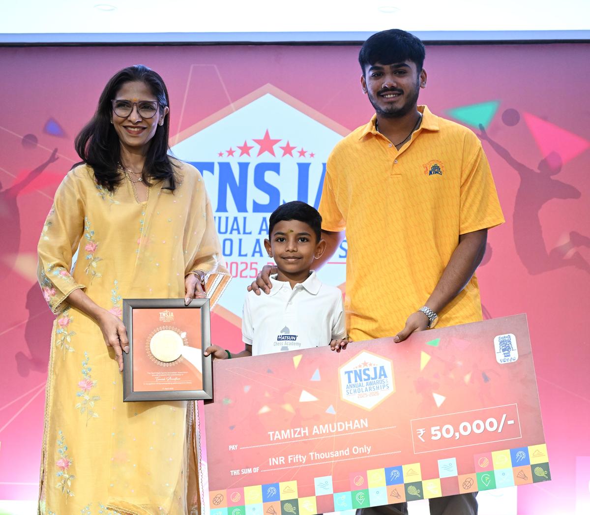 A junior awardee with the scholarship cheque