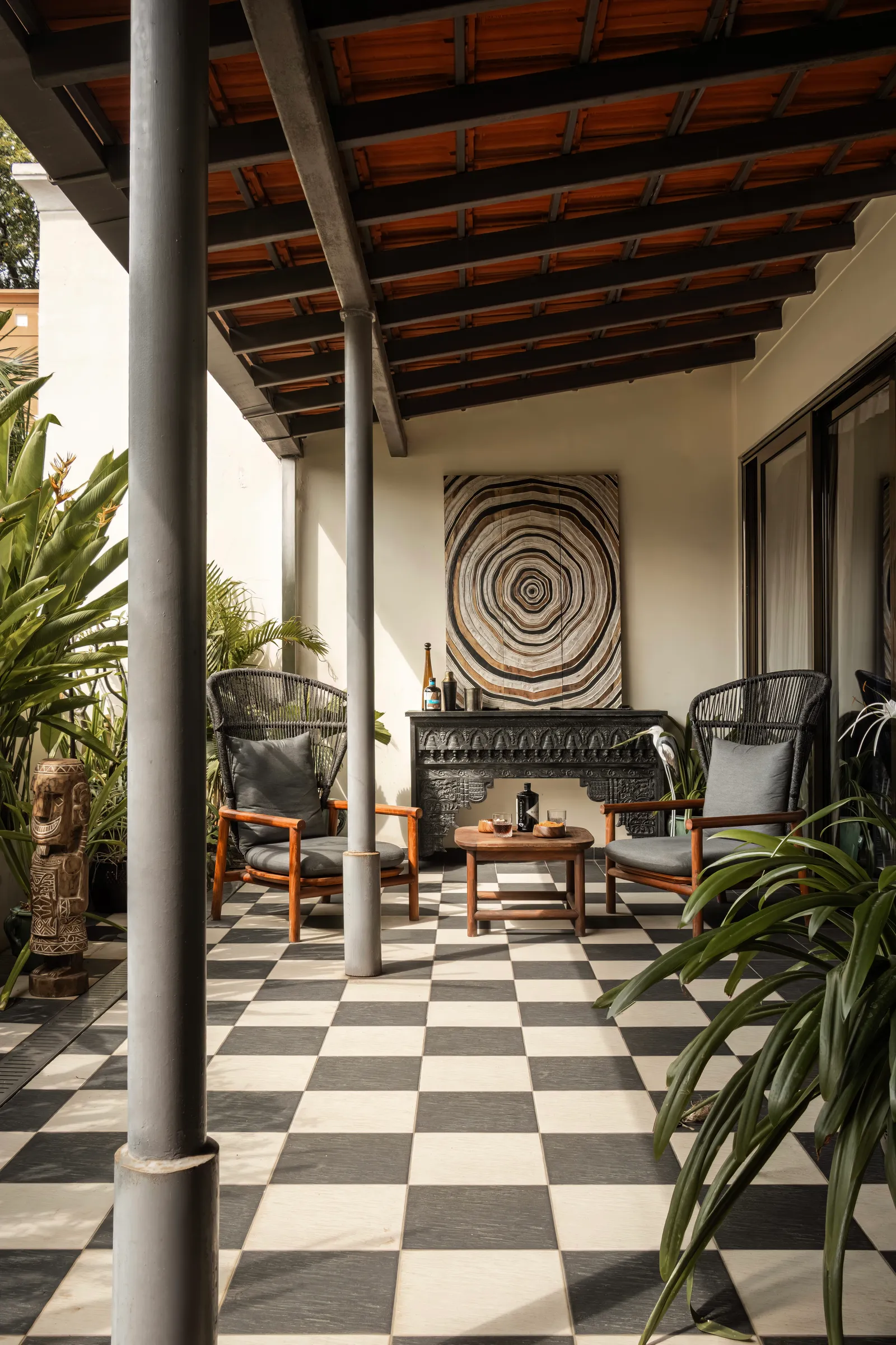 A checkerboard veranda opens the home to the outdoors