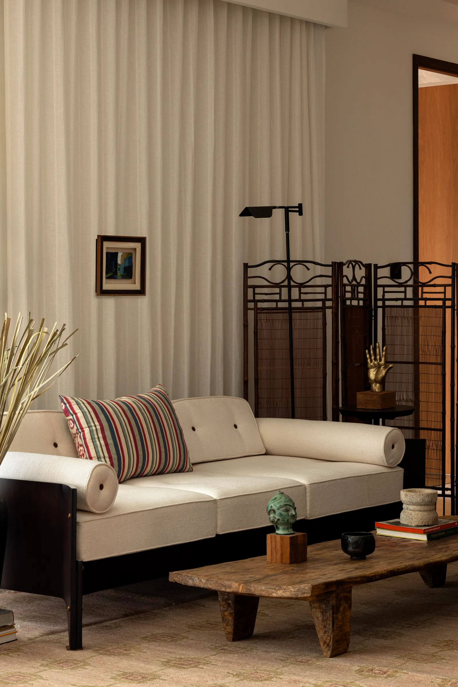 A serene seating vignette against a wrought-iron screen
