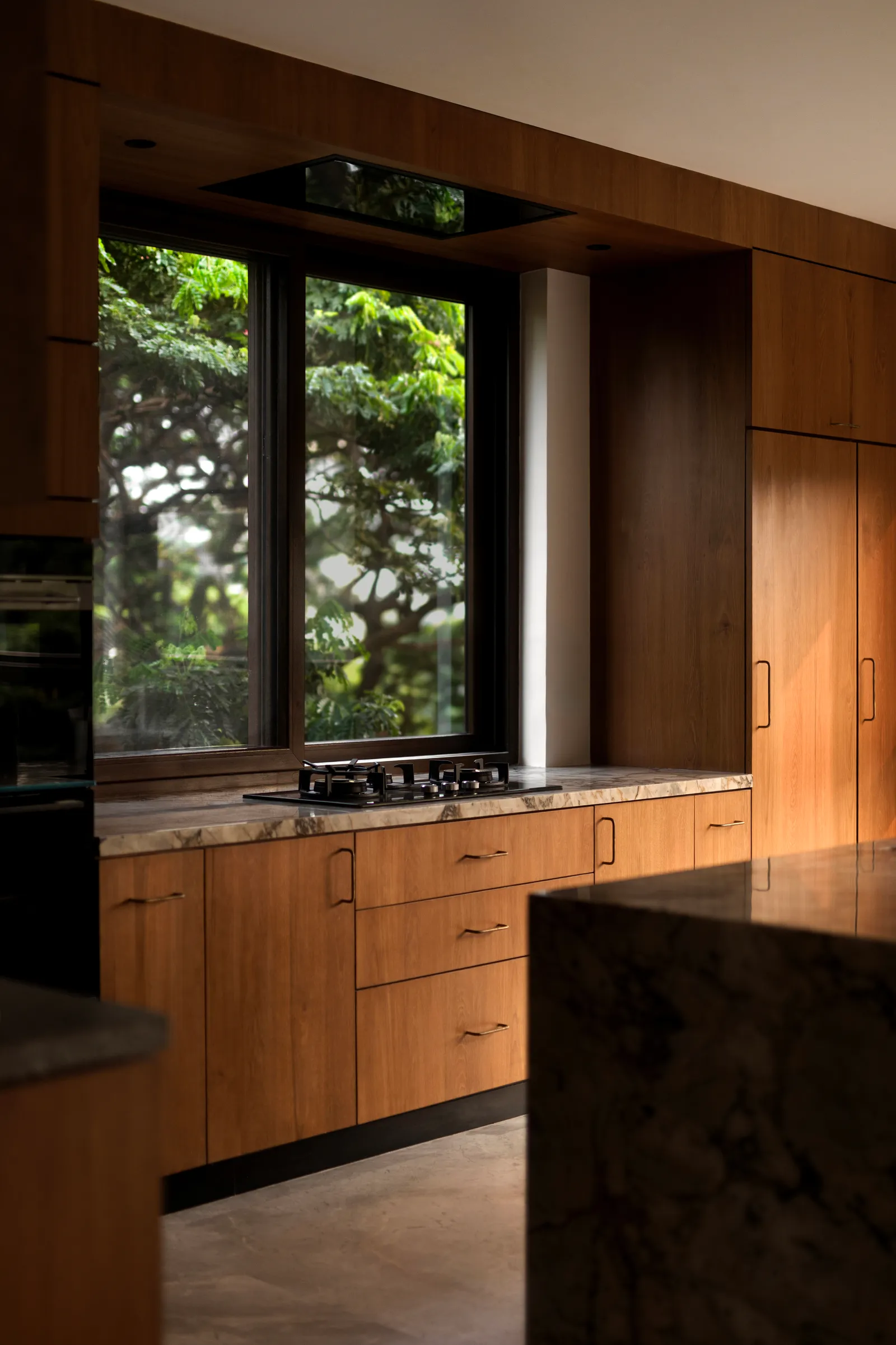 A warm wood kitchen with stone counters