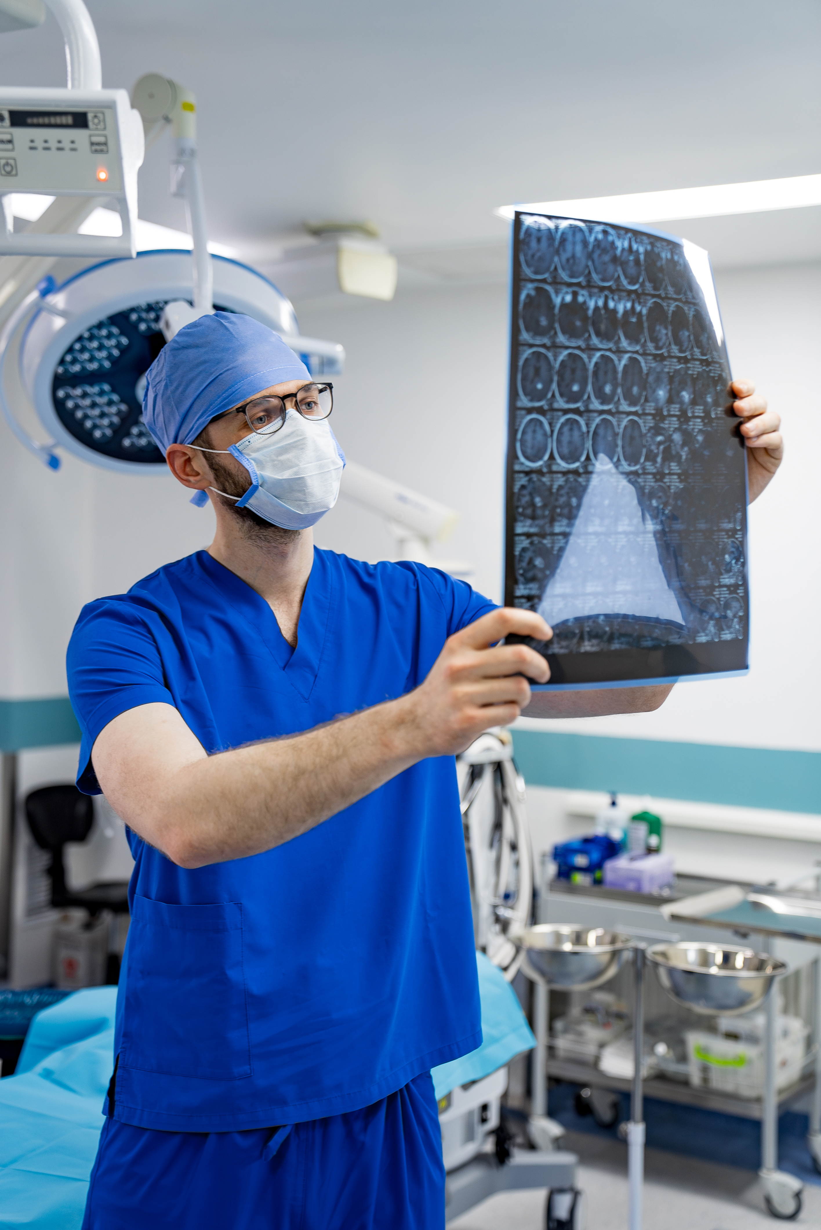 Neurologist reviewing CT brain scans at RoyalCare Hospital