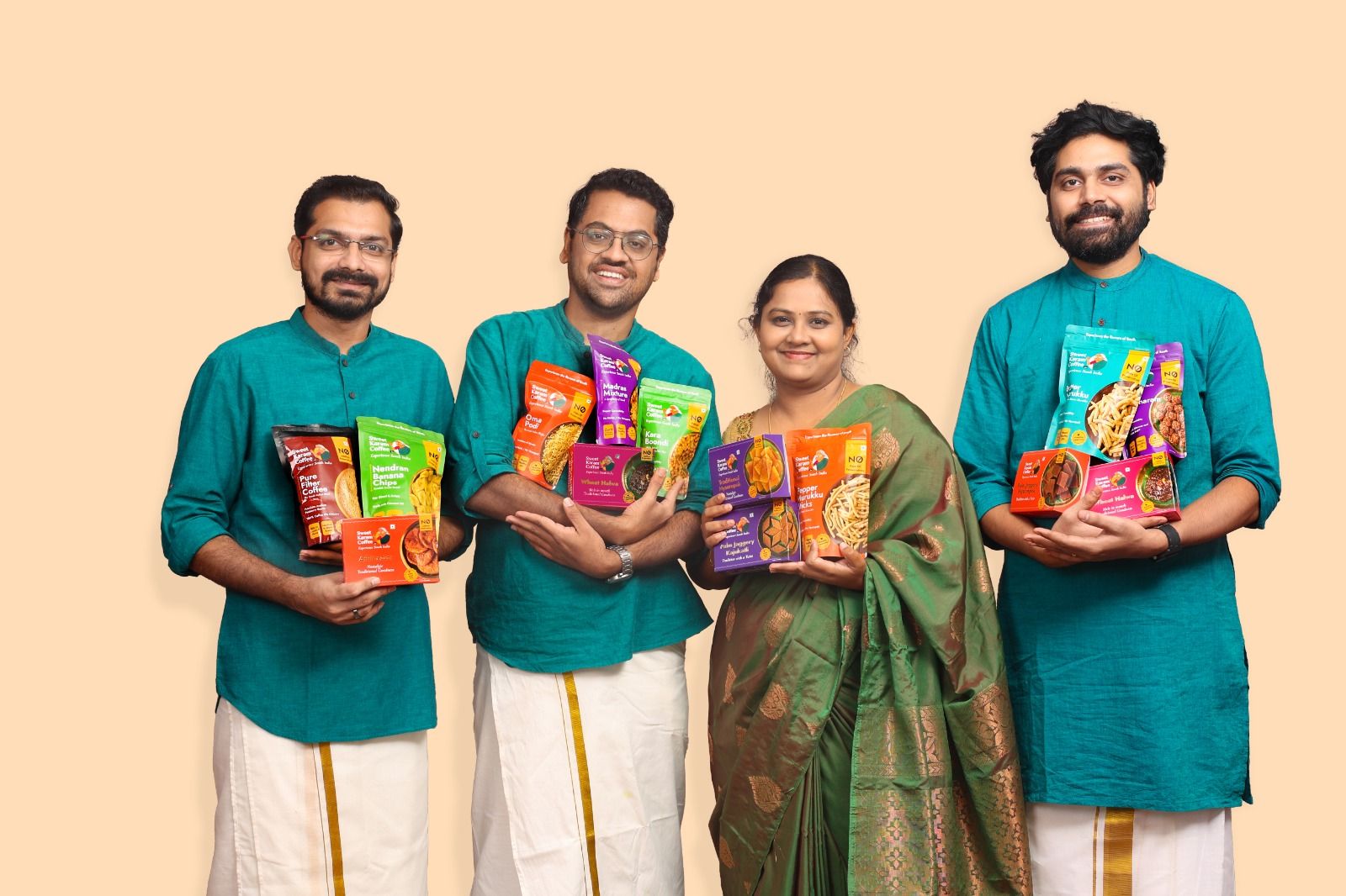 The four co-founders of Sweet Karam Coffee holding product packets